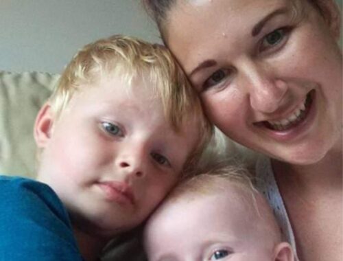 Lisa and her two boys looking into the camera