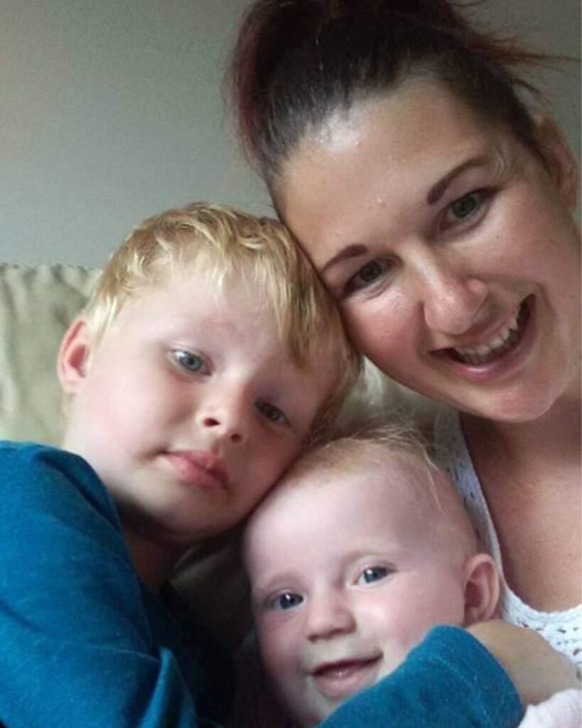 Lisa and her two boys looking into the camera.