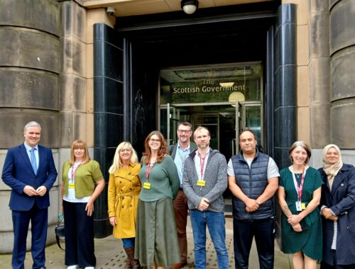 a crowd of people standing in front of a building