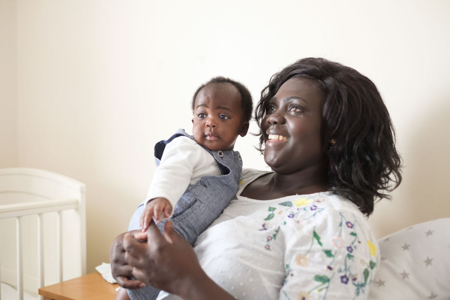 A mum holding a toddler in her arms