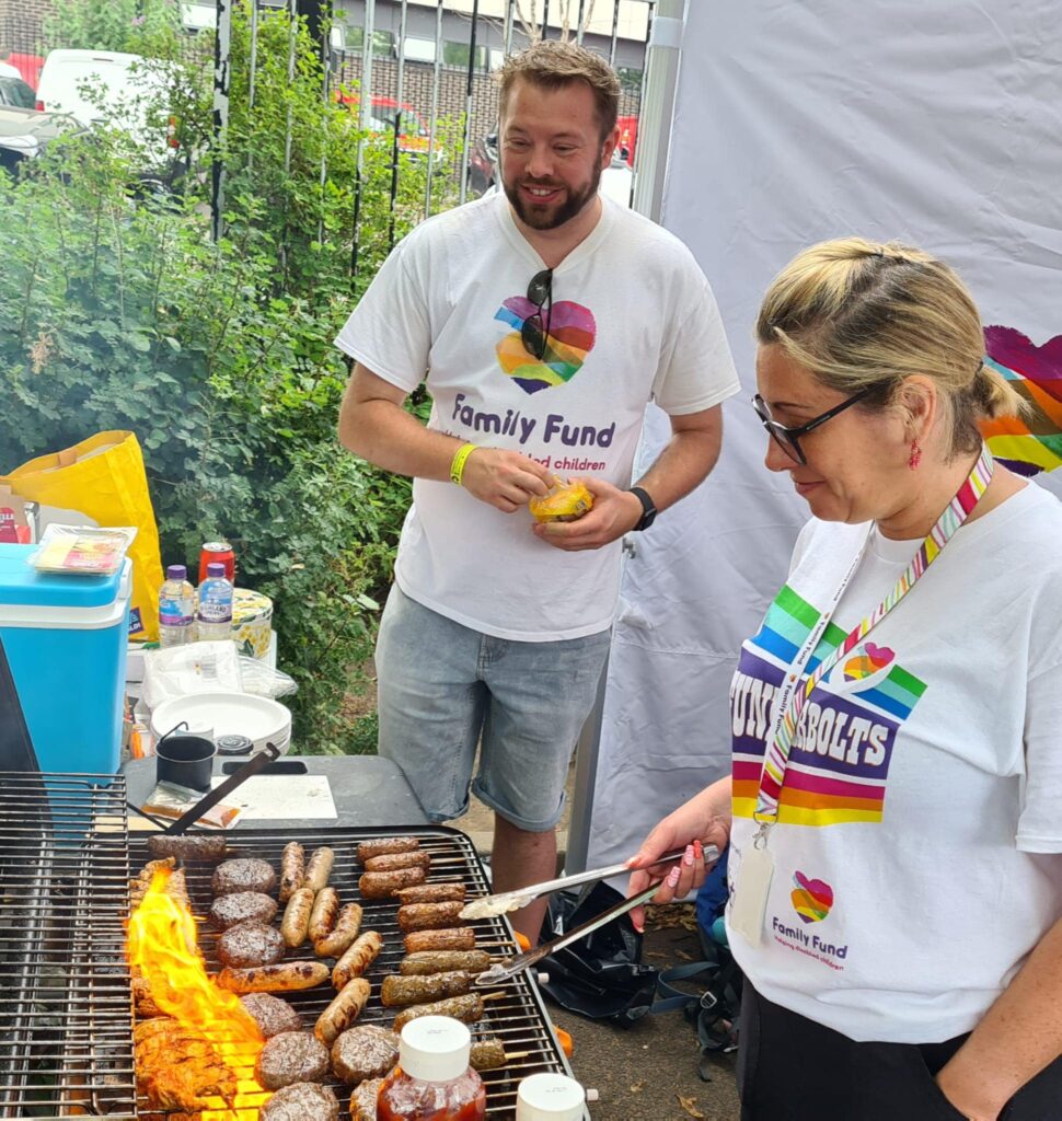 Chris, Risk and Compliance Manager at Family Fund, helps out with a fundraising barbecue alongside a colleague. 
