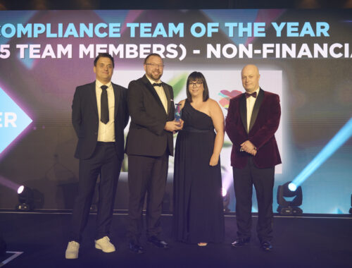 A group of people standing on stage holding an award