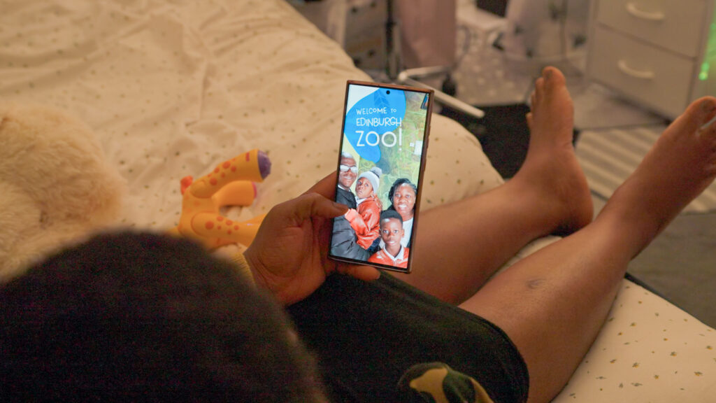 Daniel and his Mum looking at her phone