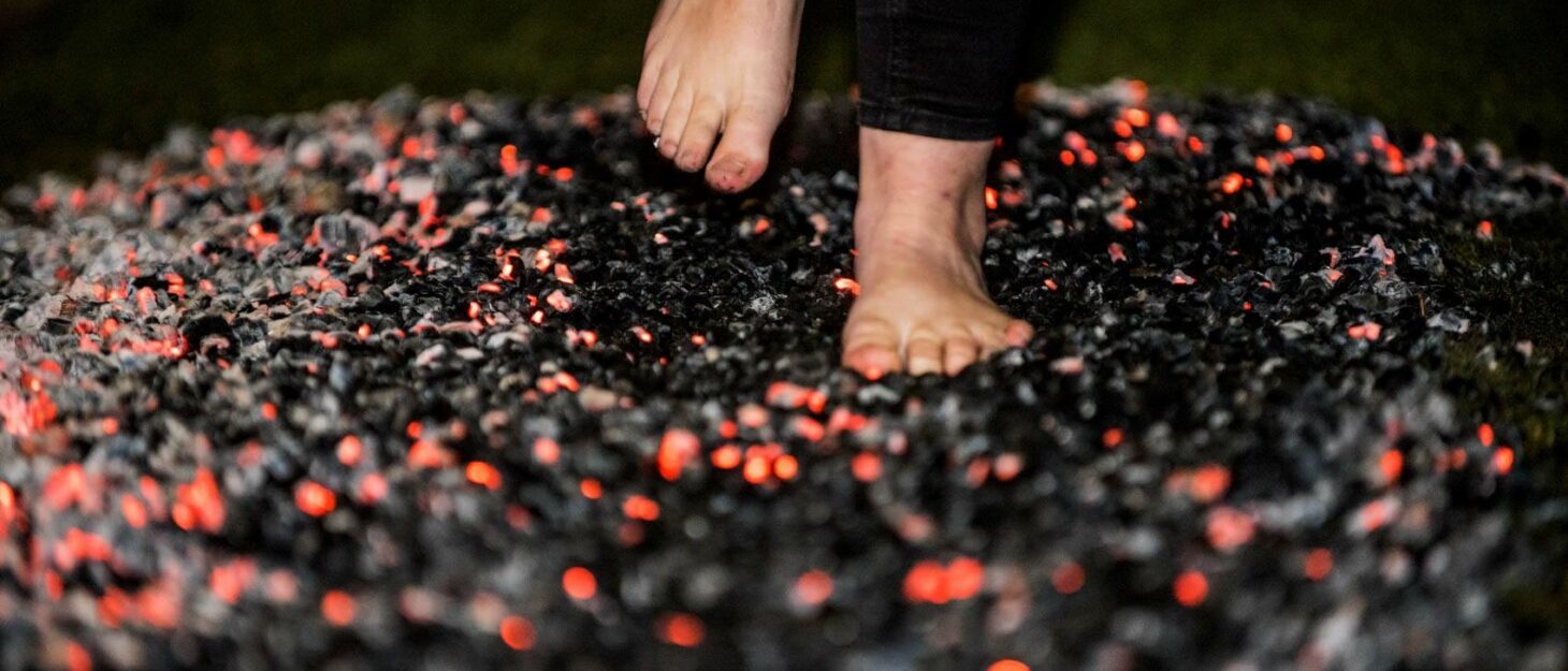 Someone walking barefoot across hot coals