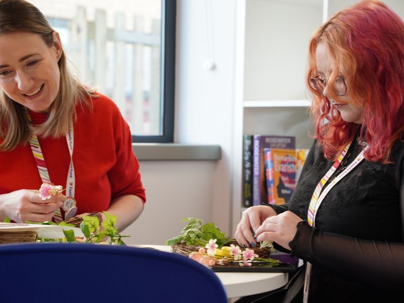 Two colleagues at a table doing Easter crafts