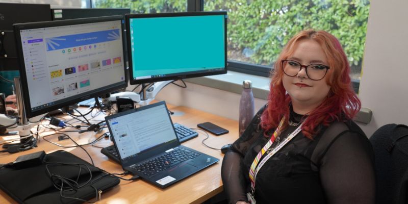 Grace, supported intern at Family Fund, sits at her desk.