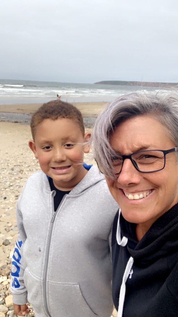 Mum takes a selfie with her son on the beach