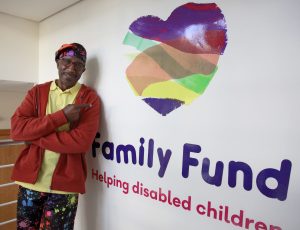 Mr Motivator in the Family Fund office, pointing at our Family Fund logo