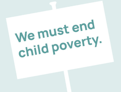 A sign with the text 'We must end child poverty.'