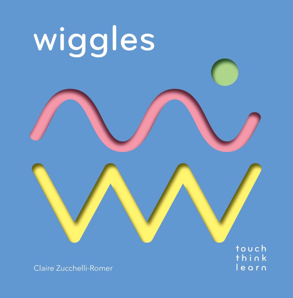A book called Wiggles with a blue cover with a pink undulating line and a yellow zig zag line on the front