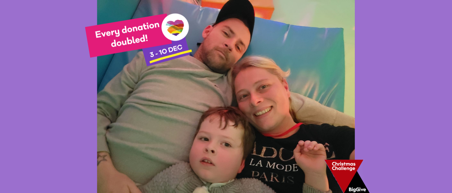 A dad, mum and son laid together on a hospital bed. A pink banner is in the top left with text 'every donation double 3-10 Dec!'