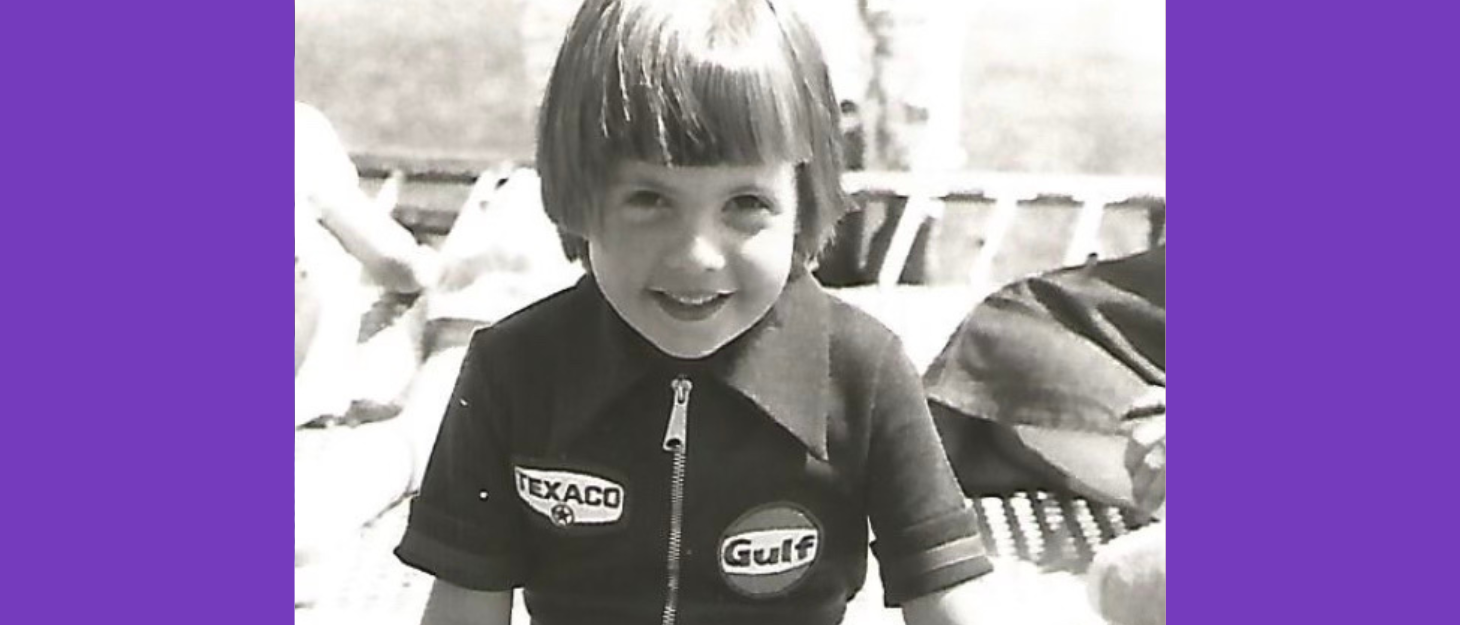 Black and white photo of young girl smiling at camera