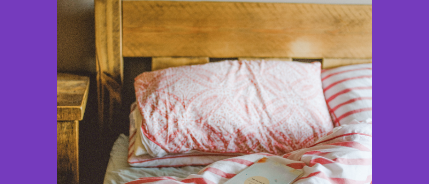 A photo of a bed with pink bedding