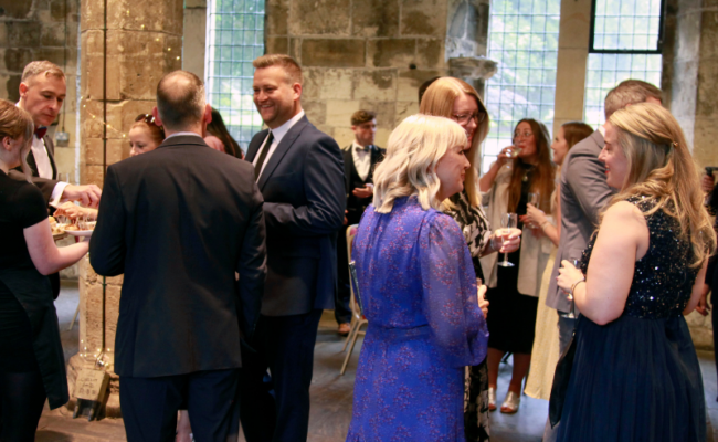 A photo of a crowd of people at a fundraising event.