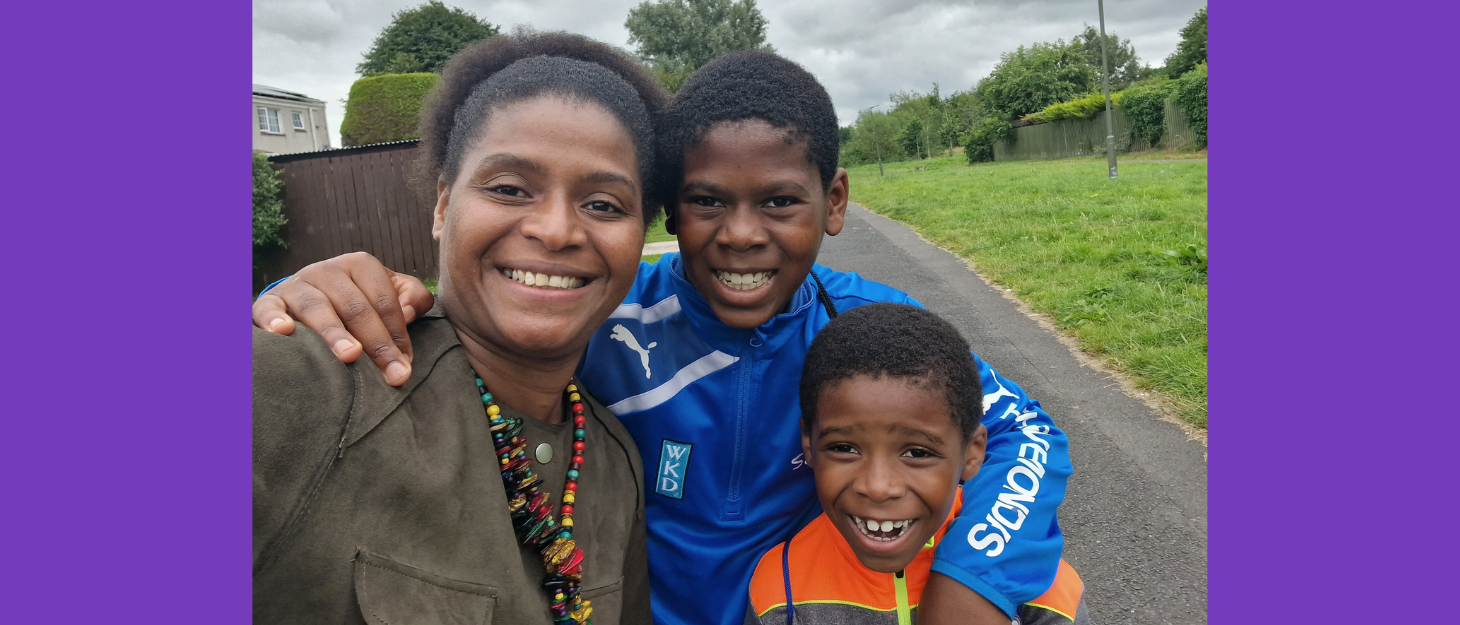 Mum takes a selfie with her two sons outside on path