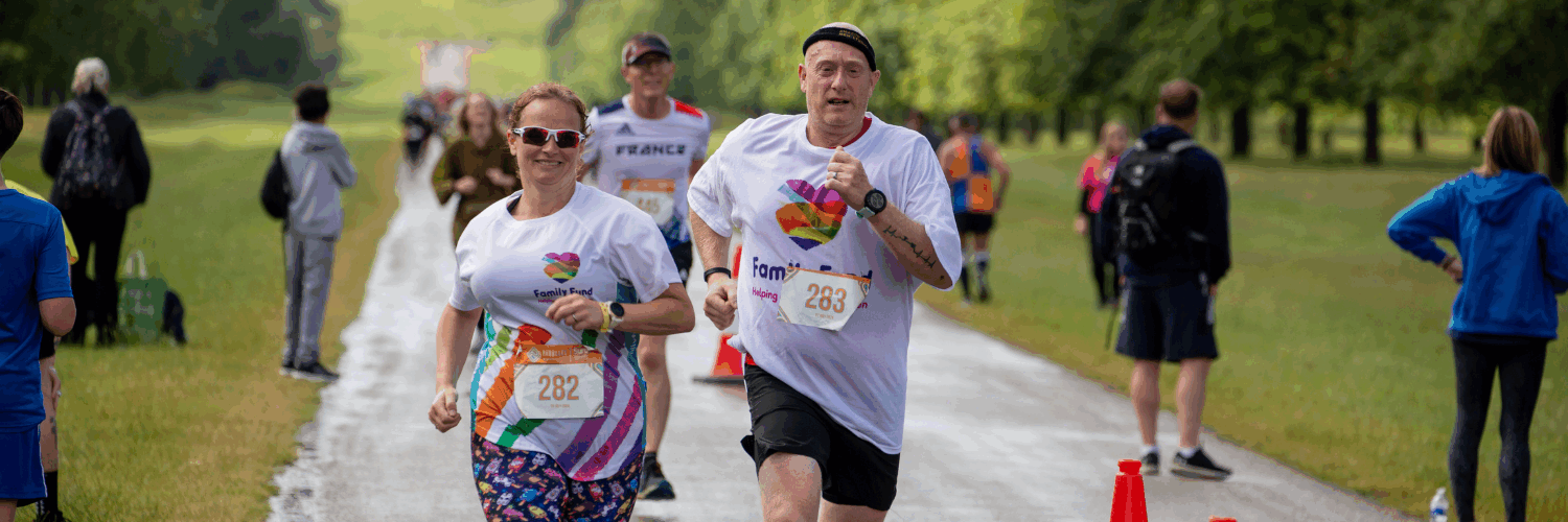 Two runners wearing Family Fund runninf vests