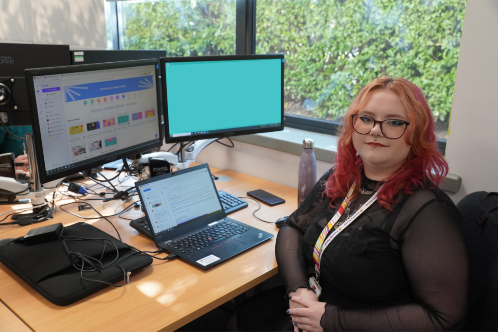 Grace, supported intern at Family Fund, sits at her desk.