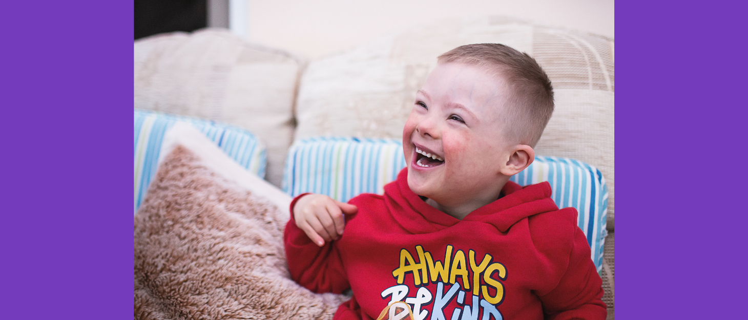 Jacob smiling whilst sitting on the sofa