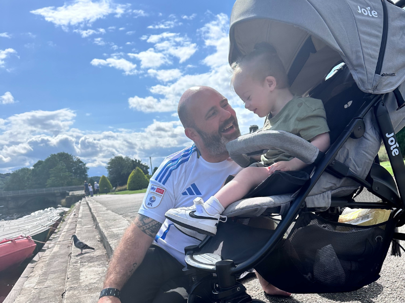Dad Peter and his son Parker, who has Down Syndrome, sit together on a day trip out using their Family Fund Mobility Support programme lease car.