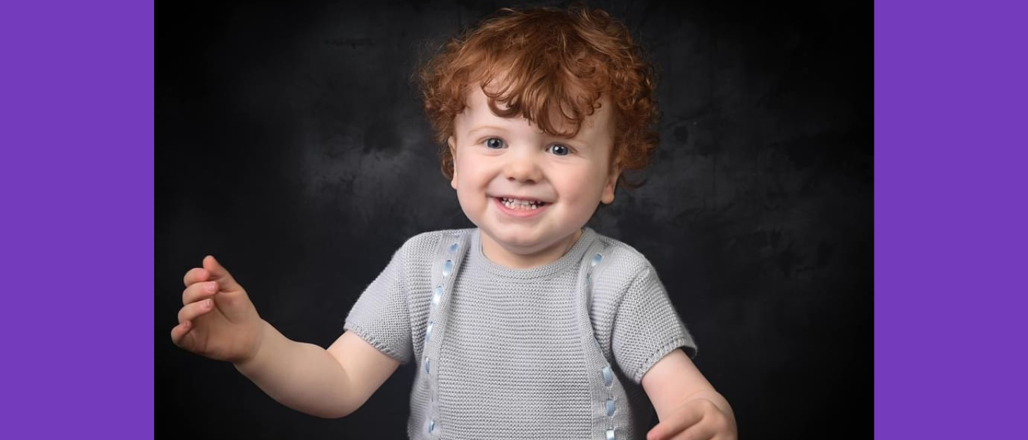 A professional photo of Theodore, he is moving his hands in joy and smiling.