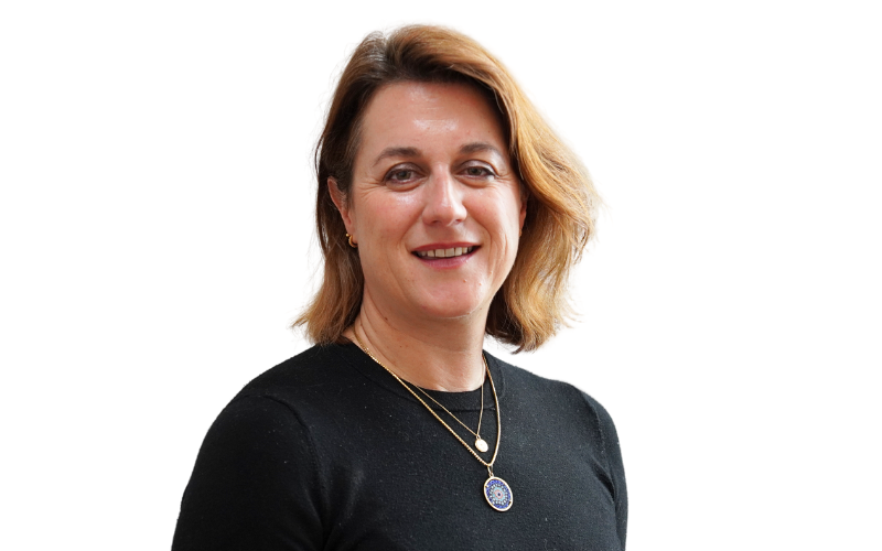 A woman wearing a black top, is smiling