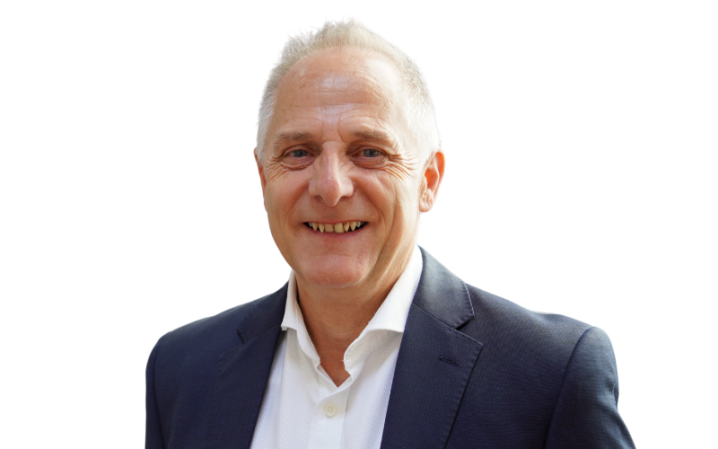 A man wearing a white shirt and a navy blazer