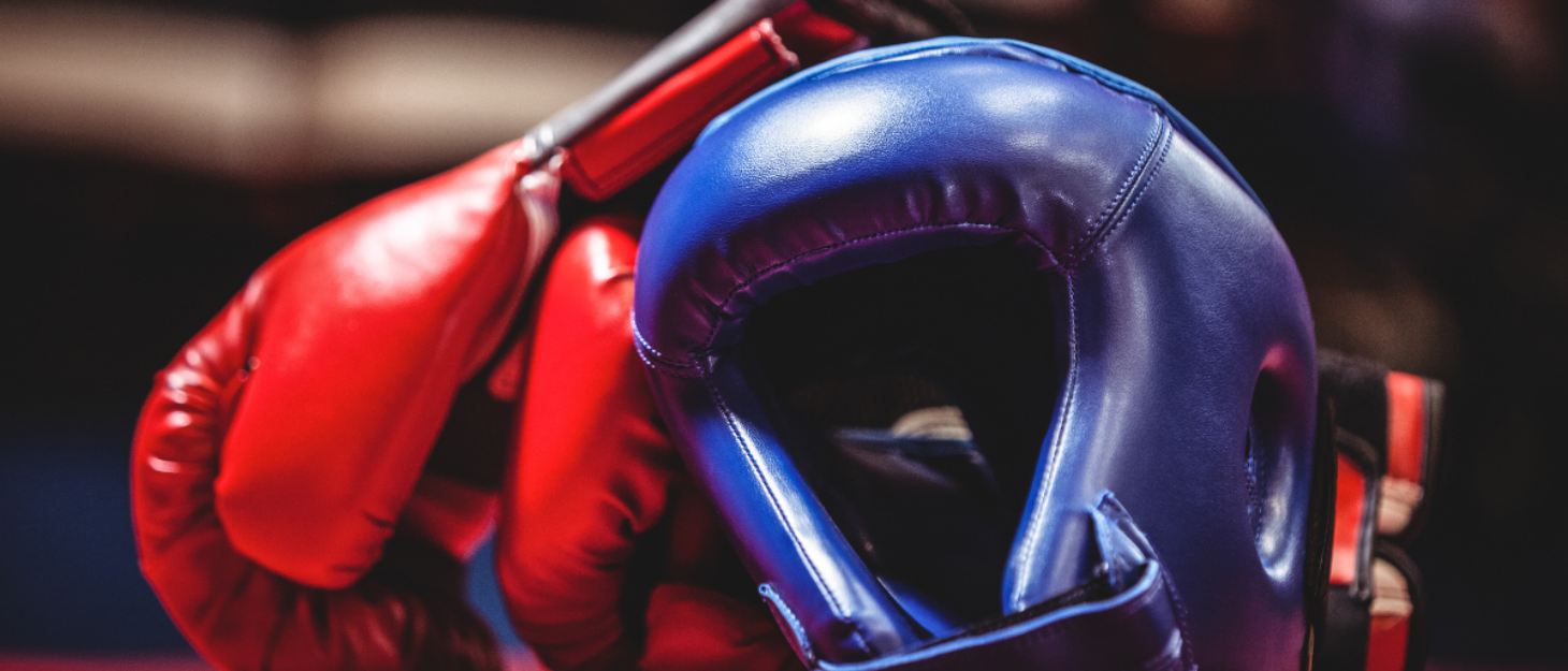 A red boxing glove and a blue boxing helmet.