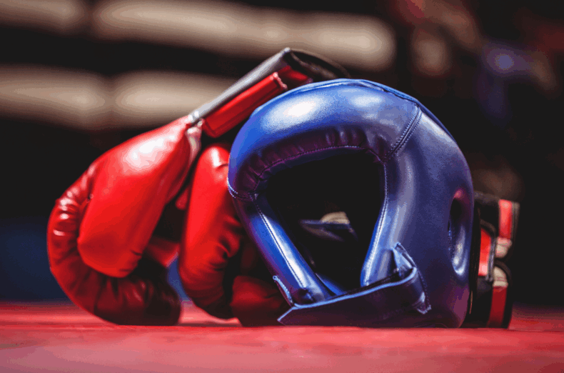 A red boxing glove and a blue boxing helmet.